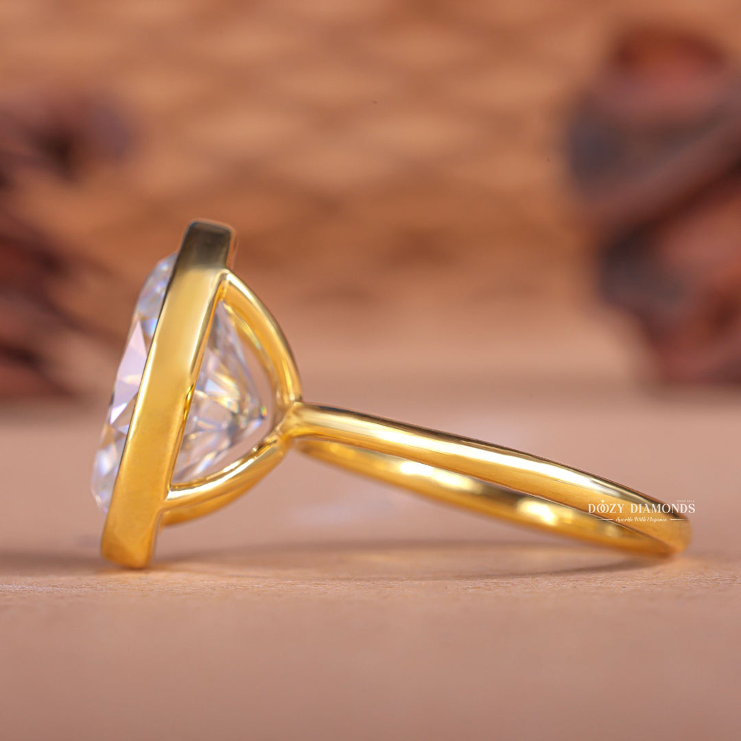 Oval bezel diamond engagement ring available in multiple metals