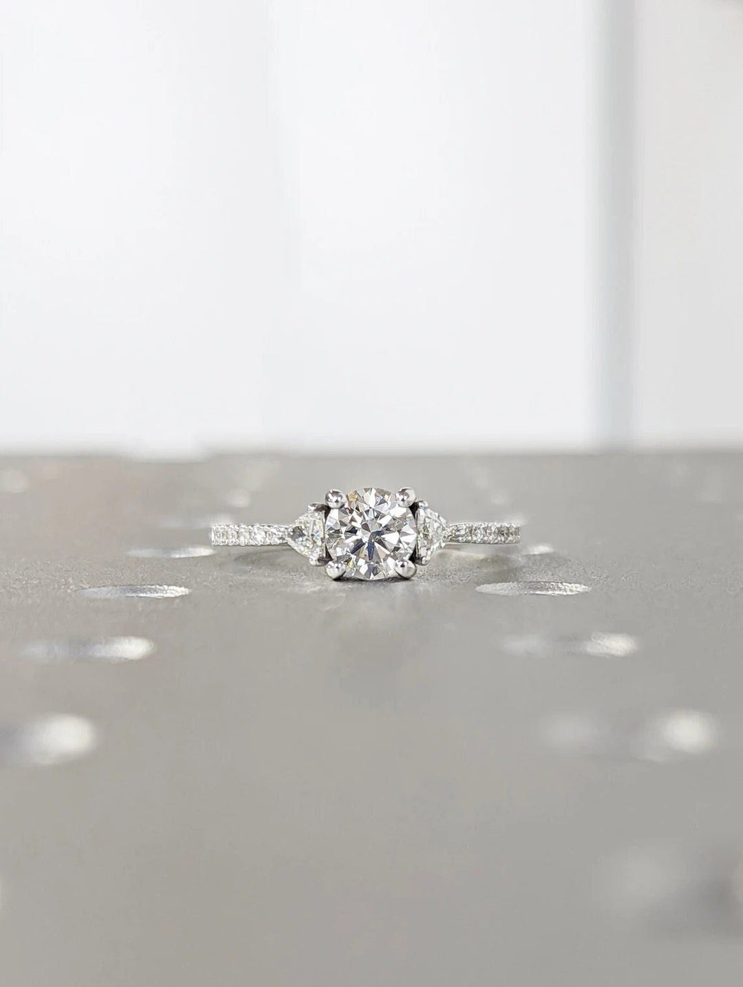 Profile view of round cut pave engagement ring band