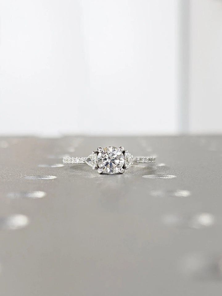 Profile view of round cut pave engagement ring band