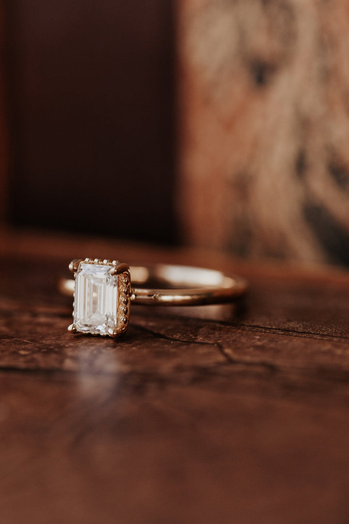 Emerald solitaire engagement ring offered in gold and platinum