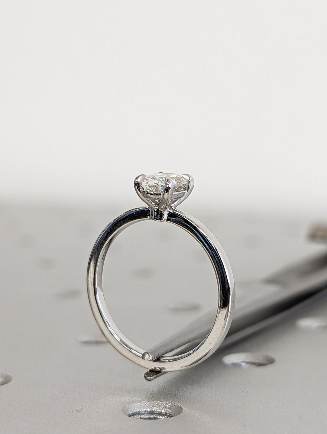 Macro shot of oval cut diamond facets in solitaire ring setting