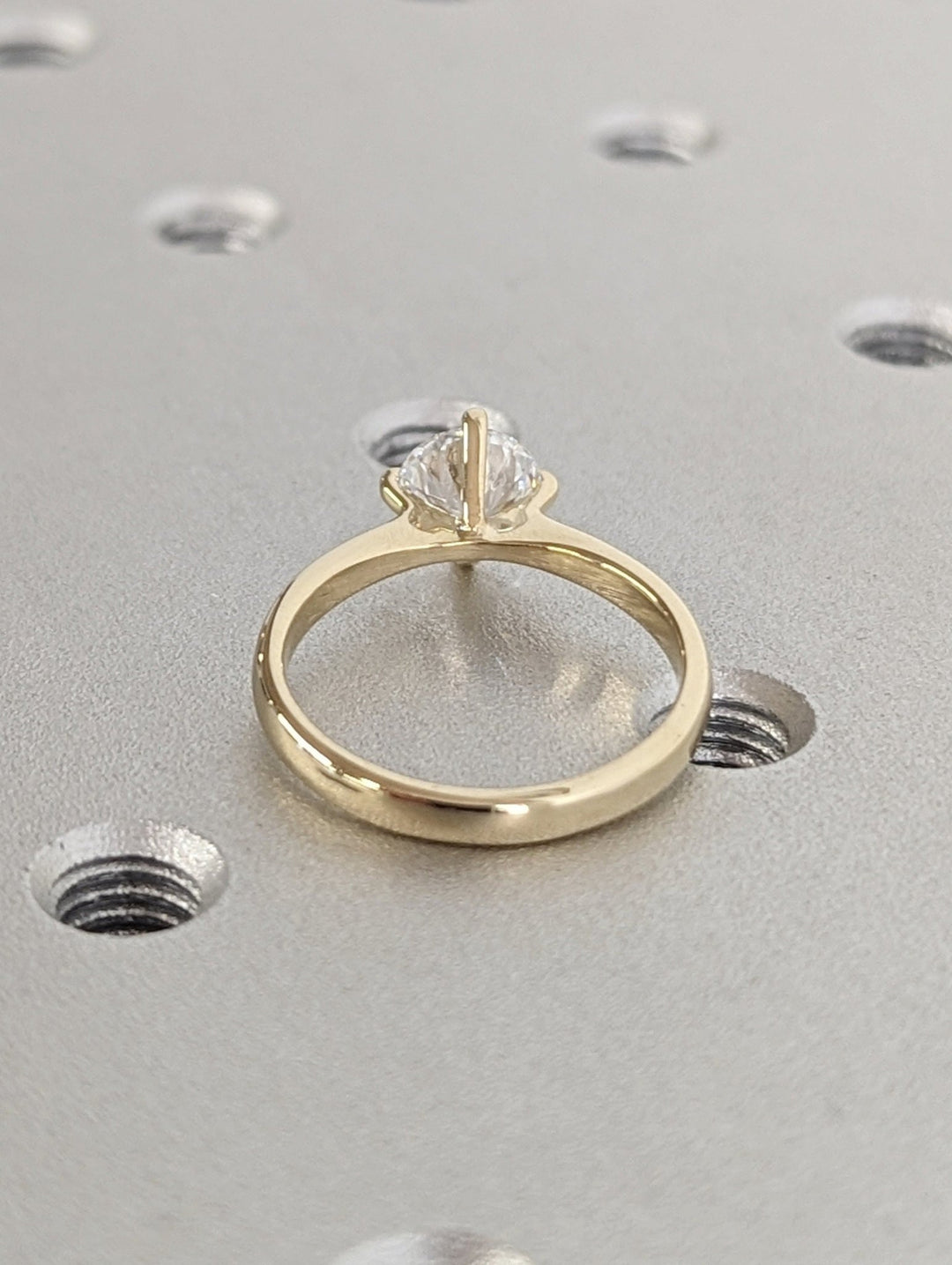Round solitaire engagement ring close-up showing high clarity diamond clarity