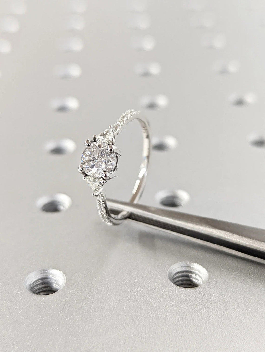 Close-up of round cut center diamond in pave engagement ring