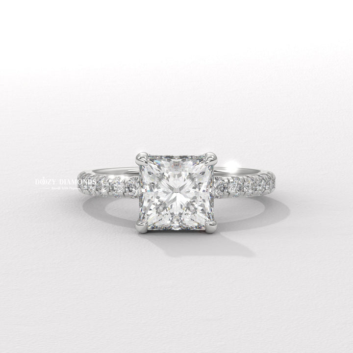 Detailed close-up of princess hidden halo diamond engagement ring