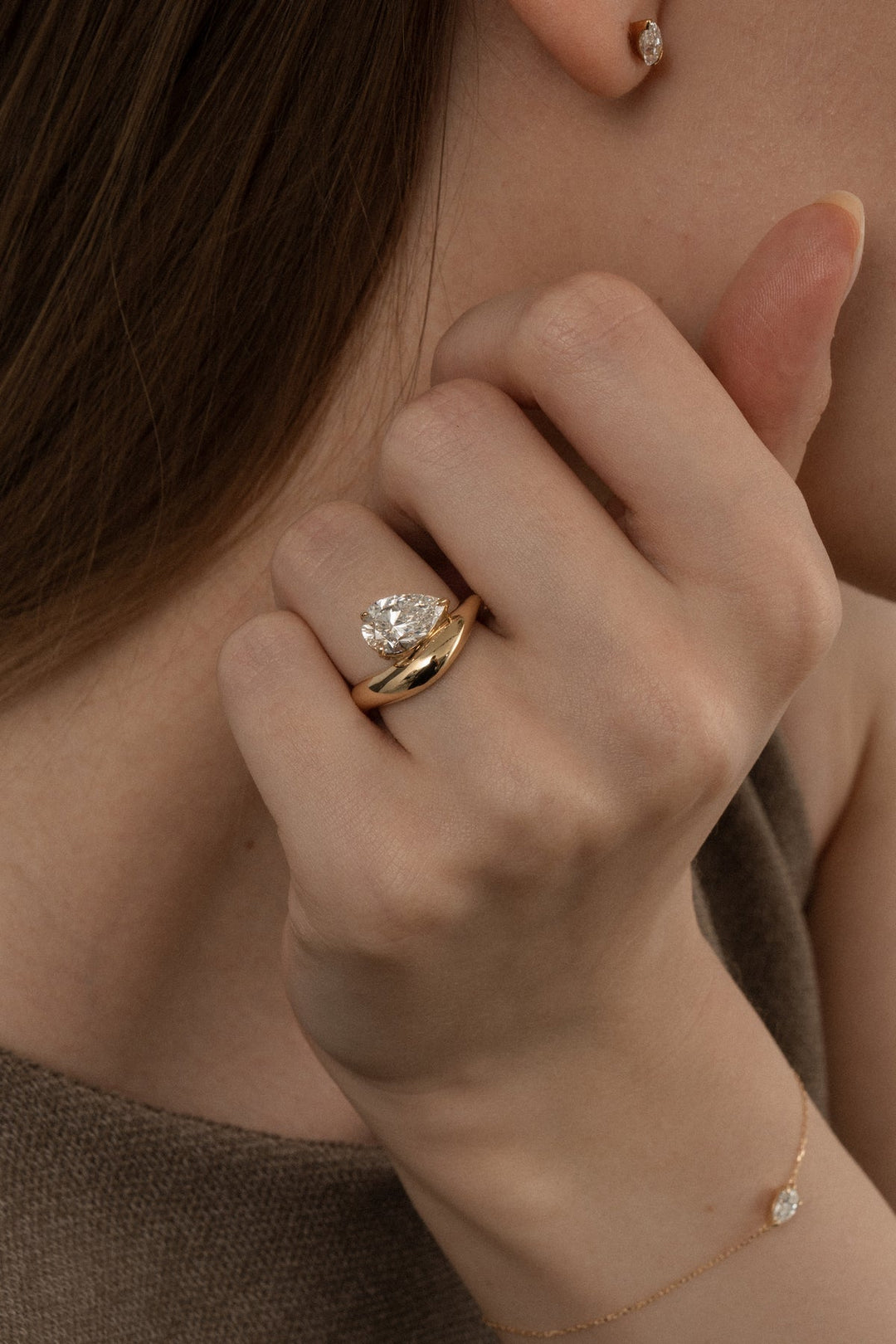 Certified pear cut diamond featured in dome engagement ring