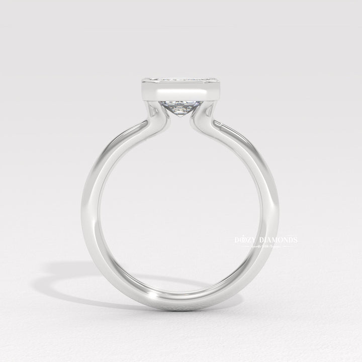 Profile view of emerald cut bezel engagement ring band