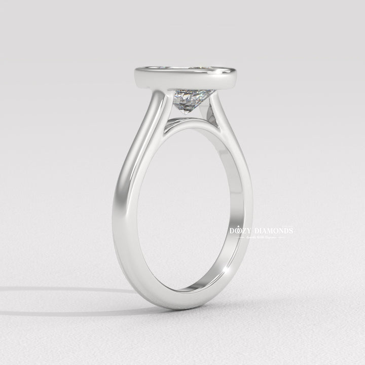 Oval bezel lab grown diamond ring side profile in gold setting