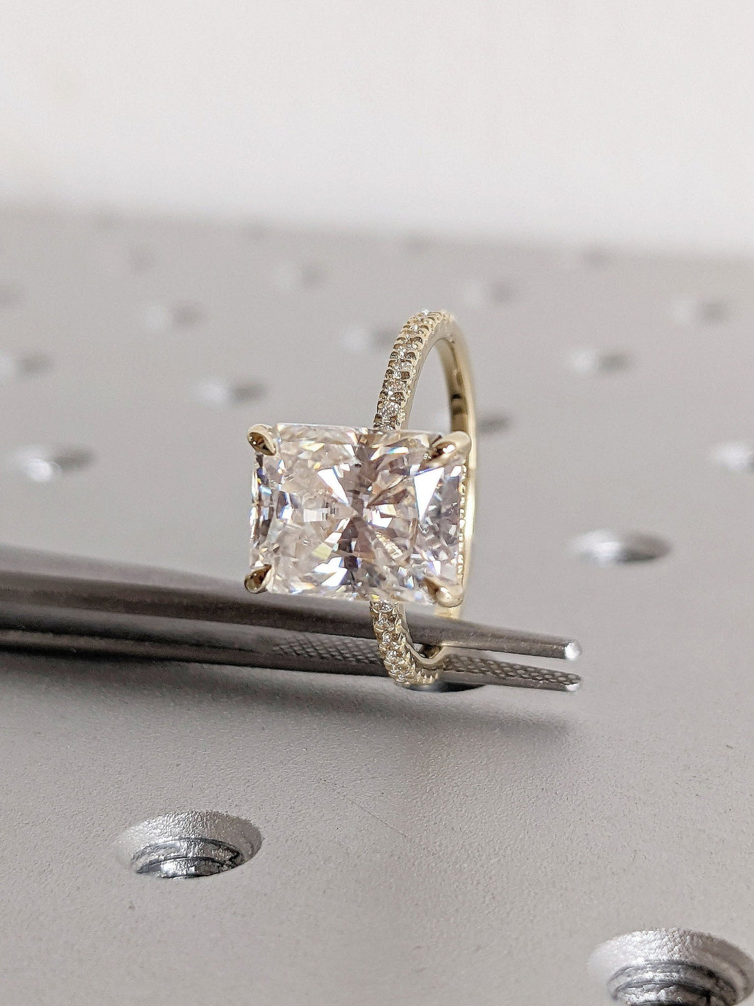 Radiant cut hidden halo engagement ring with IGI certified center diamond