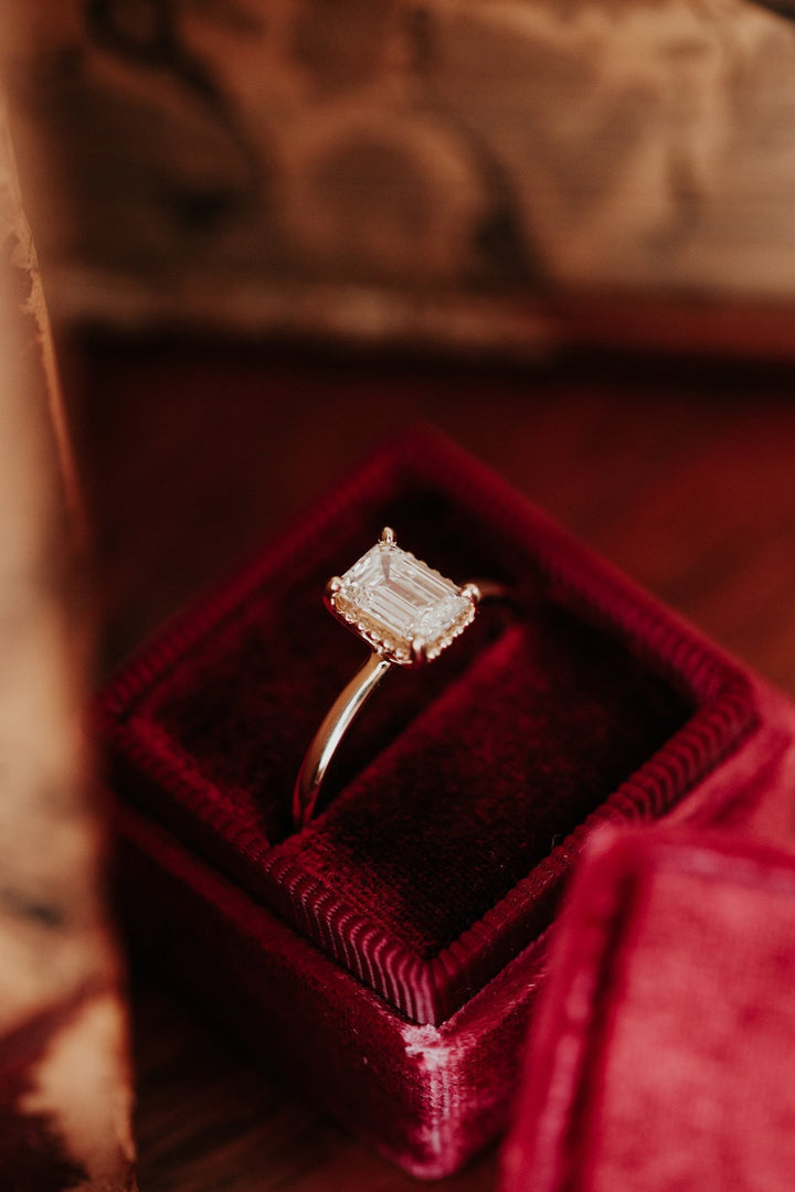 Emerald solitaire diamond ring presented in signature gift packaging