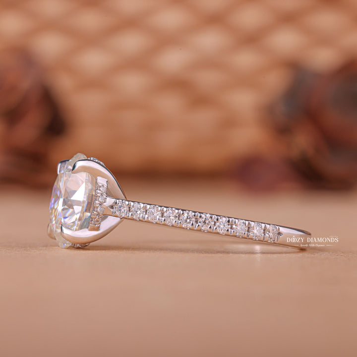 Round hidden halo engagement ring viewed from the side
