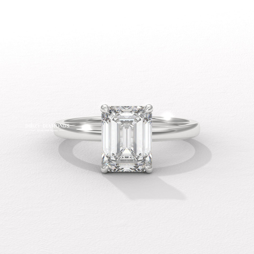 Emerald solitaire engagement ring photographed in natural light