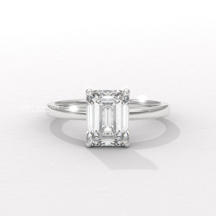 Emerald solitaire engagement ring photographed in natural light