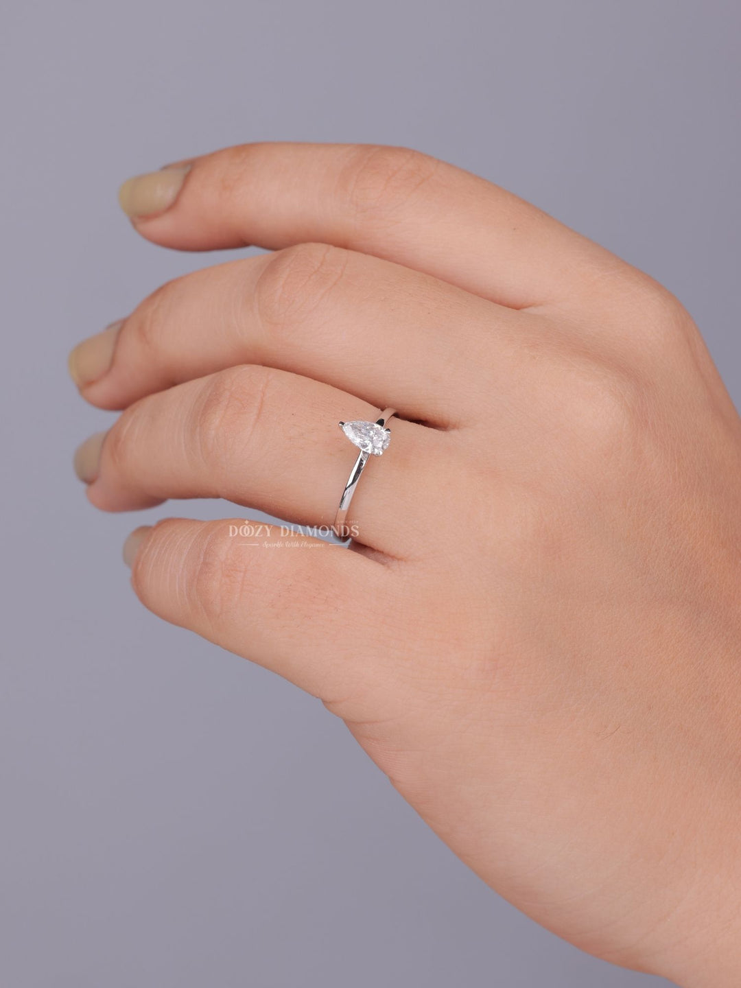 Pear cut diamond ring worn on hand