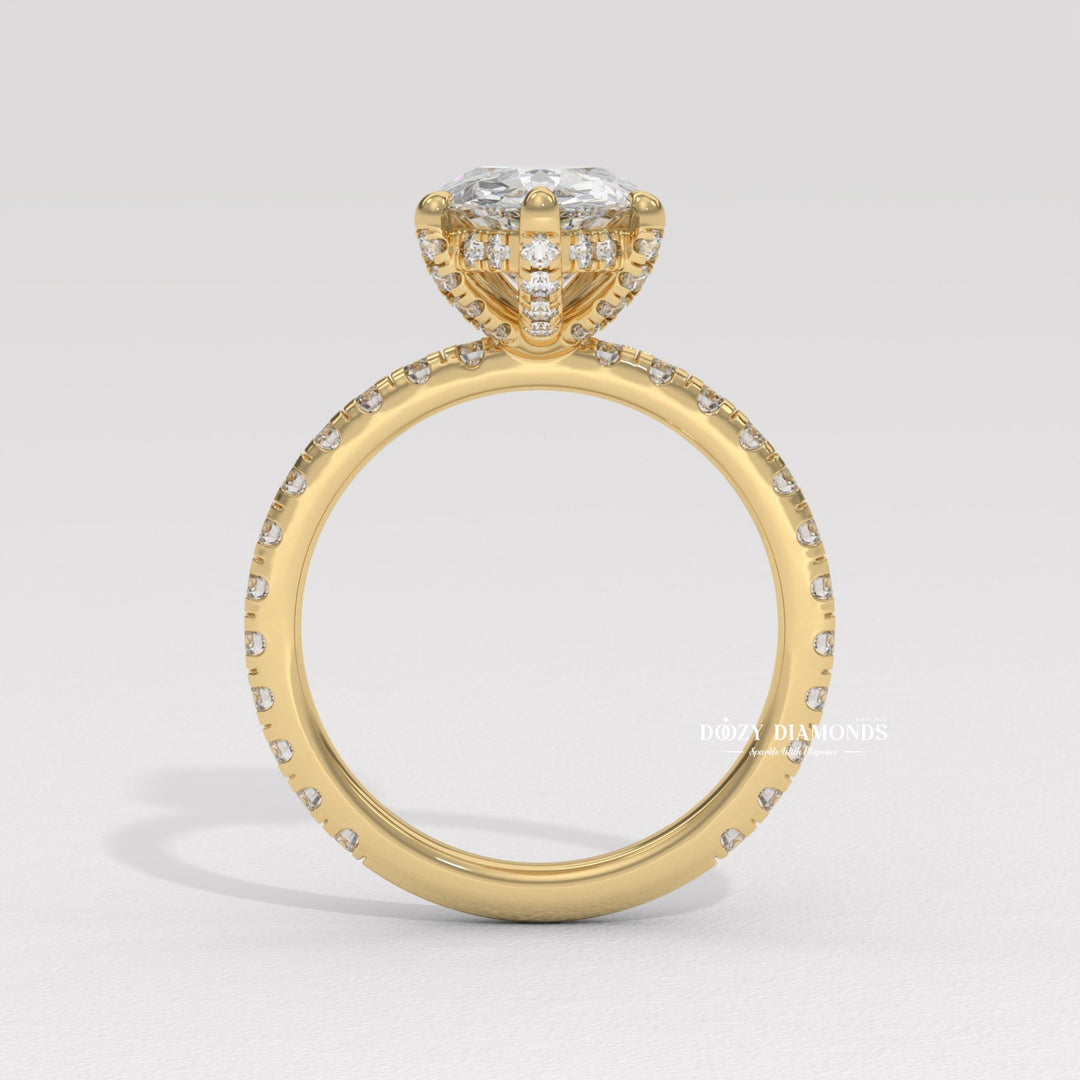 Pear hidden halo engagement ring photographed in natural light