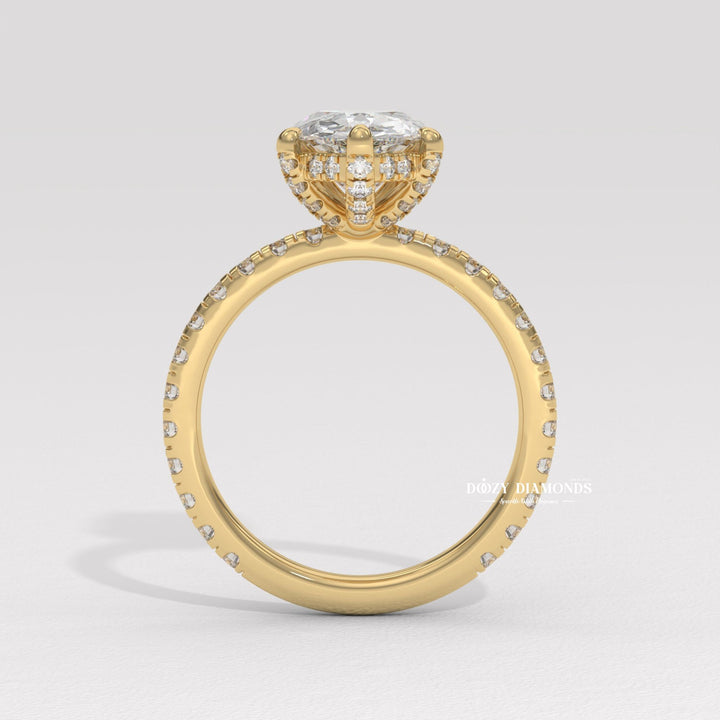 Pear hidden halo engagement ring photographed in natural light