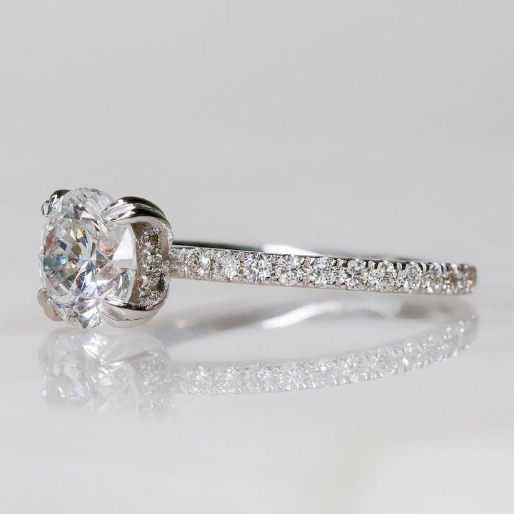 Round hidden halo engagement ring photographed in natural light
