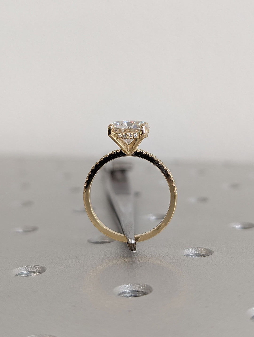 Side angle of round hidden halo diamond engagement ring
