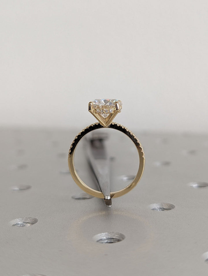 Side angle of round hidden halo diamond engagement ring