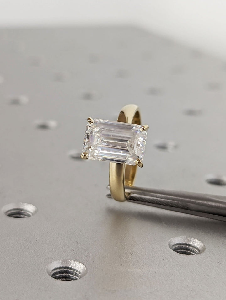 Detailed close-up of emerald solitaire diamond engagement ring