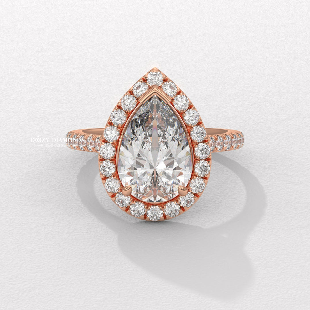 Close-up of pear cut center diamond in halo engagement ring