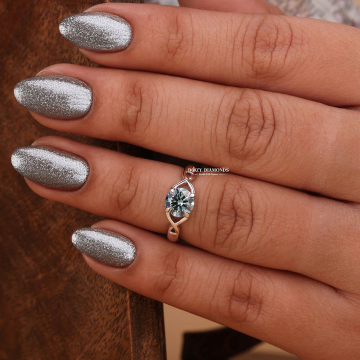 Lifestyle shot of round solitaire diamond ring on hand