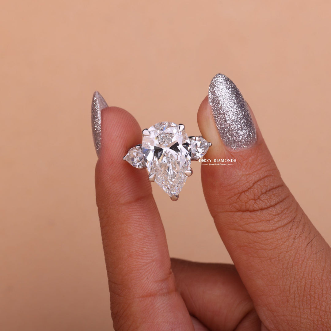 Pear cut engagement ring shown with authenticity certificate
