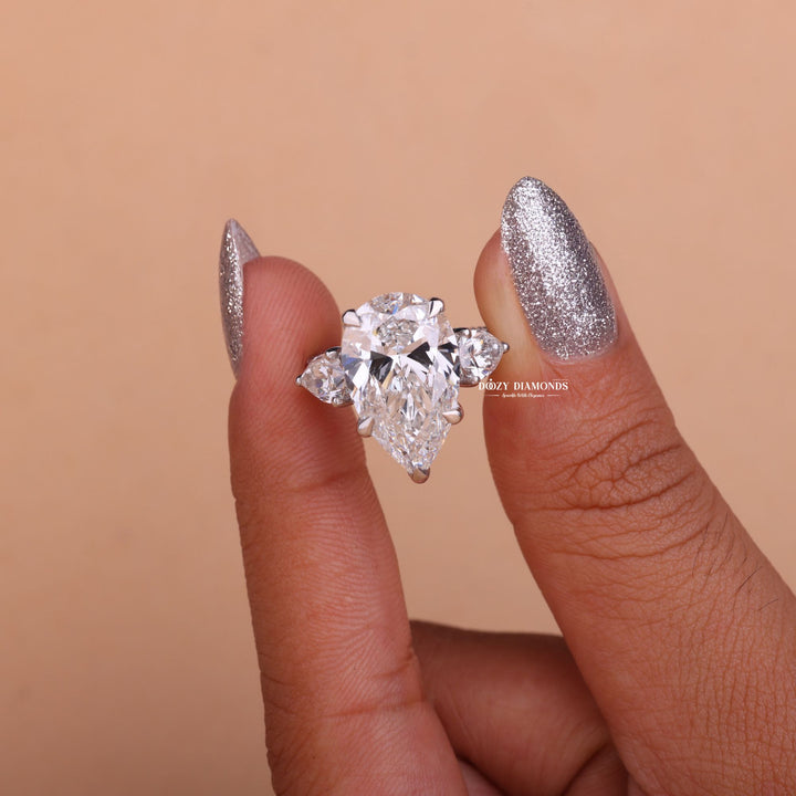 Pear cut engagement ring shown with authenticity certificate