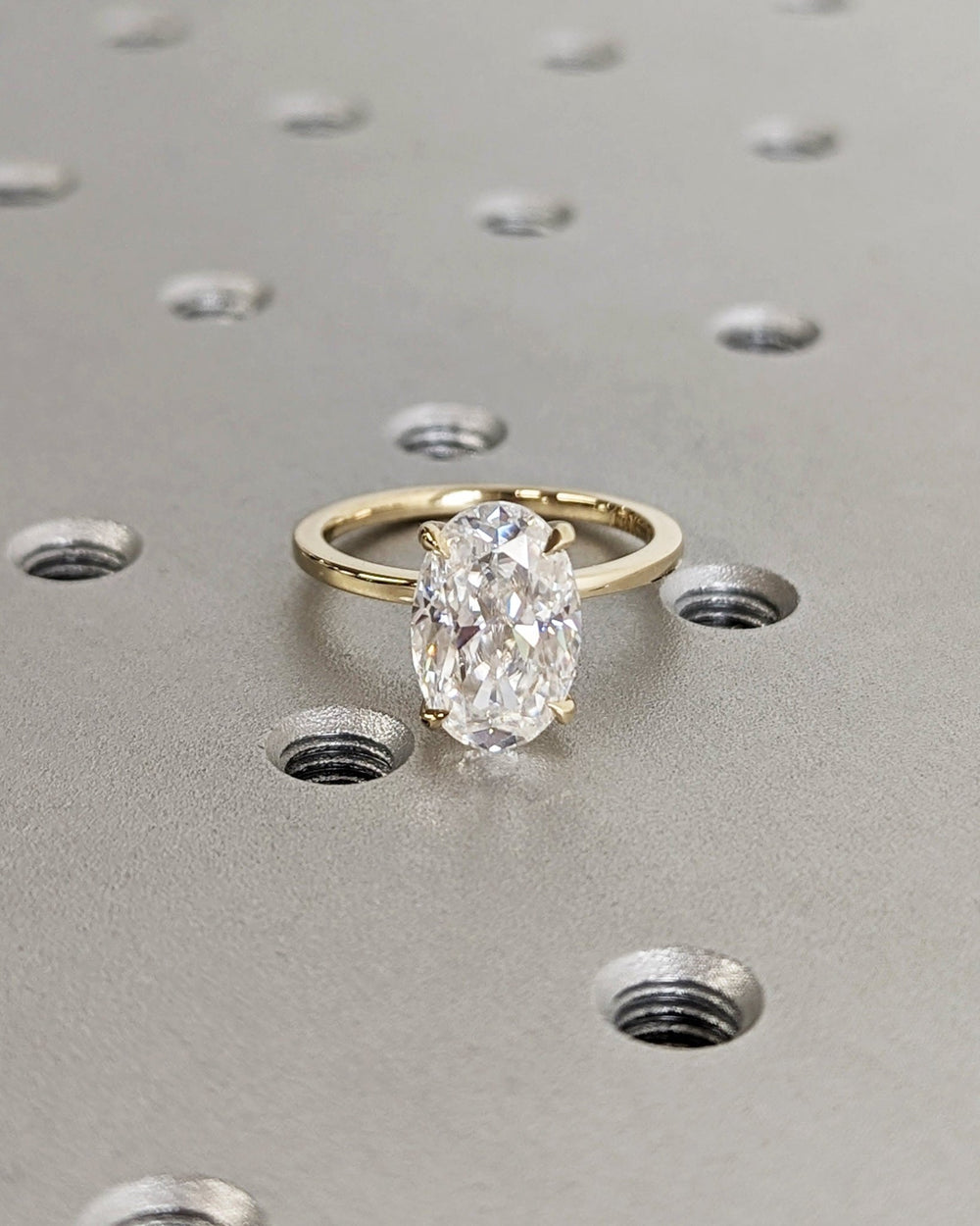 Side angle of oval solitaire diamond engagement ring