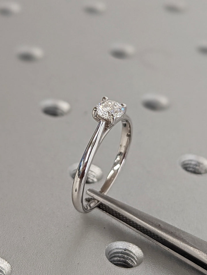 Round solitaire lab grown diamond ring fitted on finger