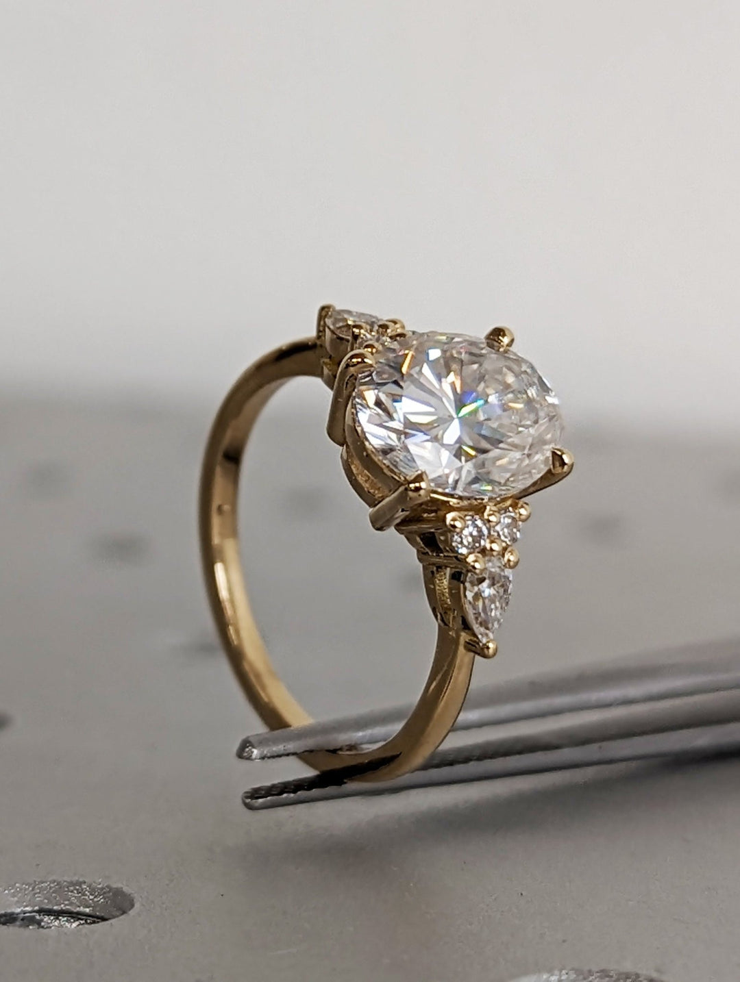 Profile view of oval cut cluster engagement ring band