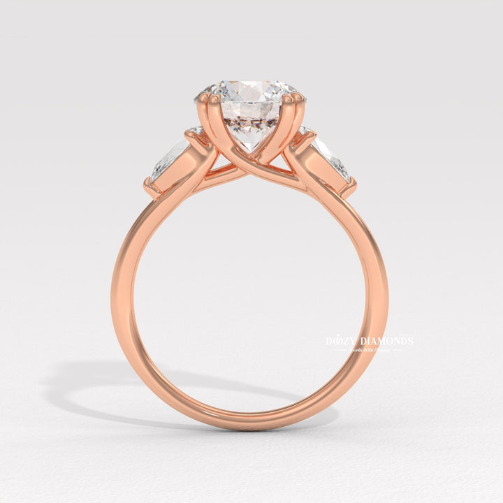 Round cut three stone engagement ring shown in real-life wear
