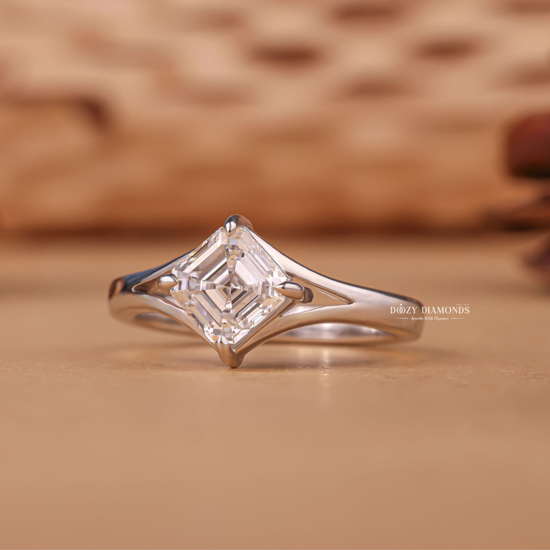 Close-up of asscher cut center diamond in split shank engagement ring