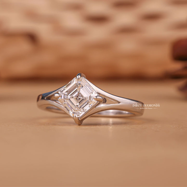 Close-up of asscher cut center diamond in split shank engagement ring