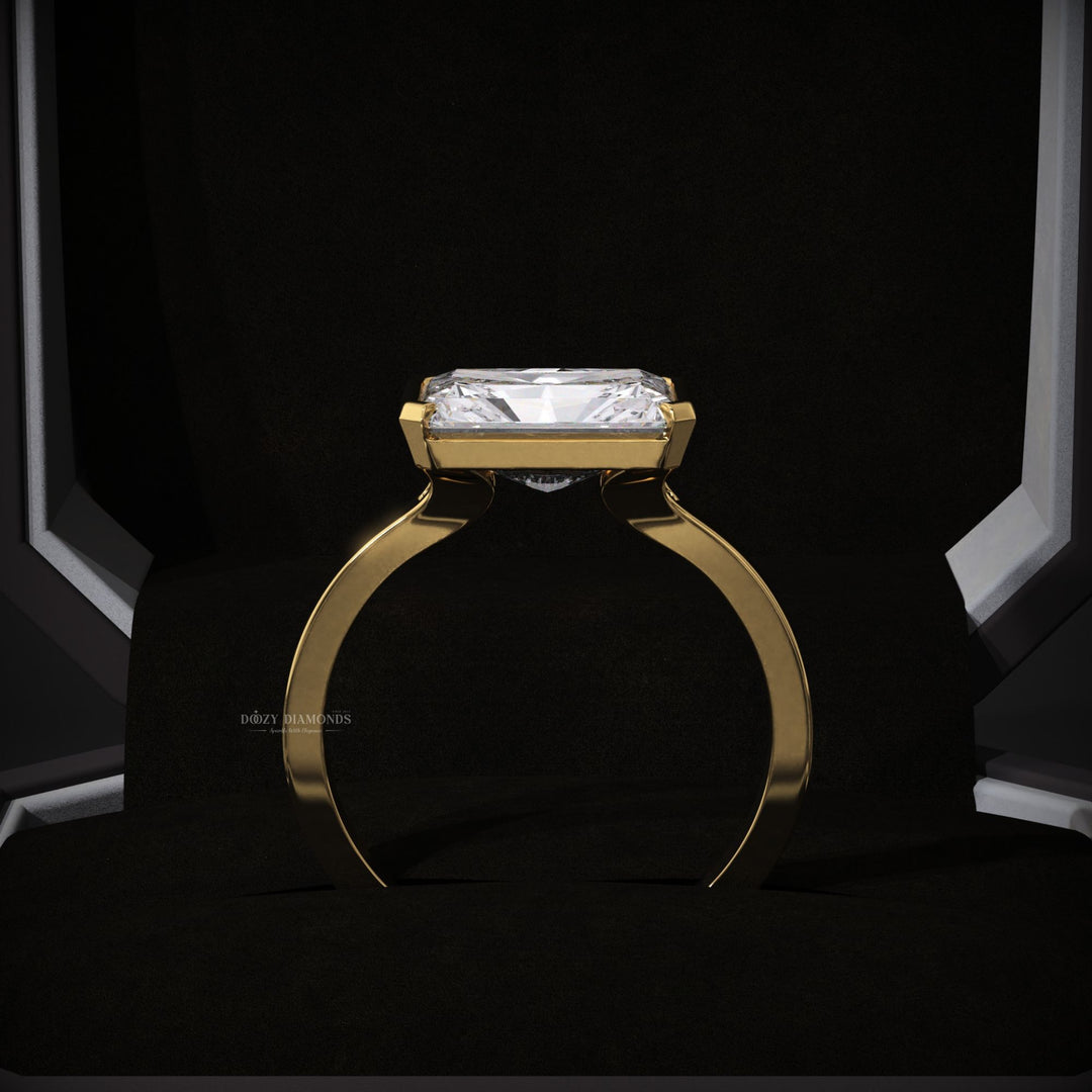 Radiant east west engagement ring viewed from the side