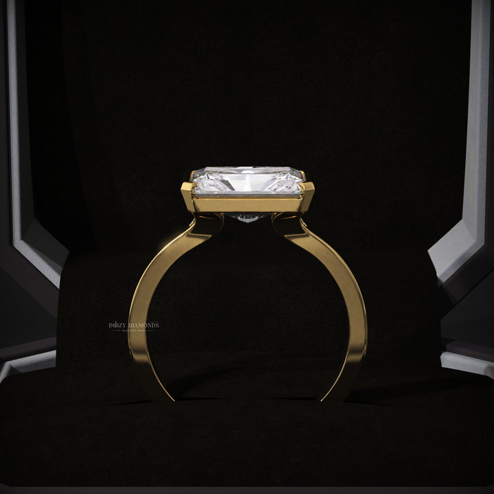 Radiant east west engagement ring viewed from the side