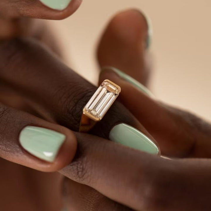 Emerald east west engagement ring viewed from the side