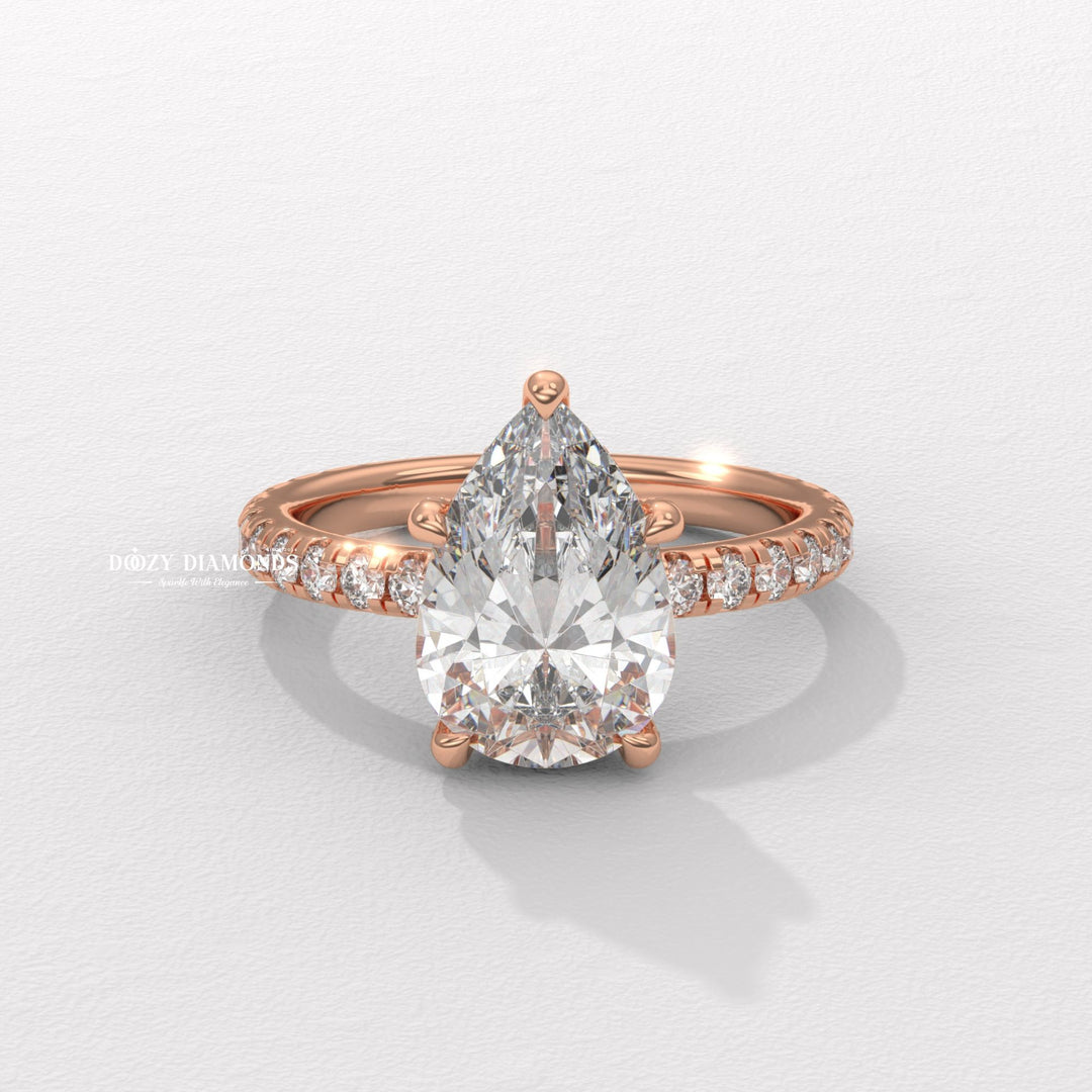 Pear hidden halo engagement ring close-up highlighting diamond sparkle