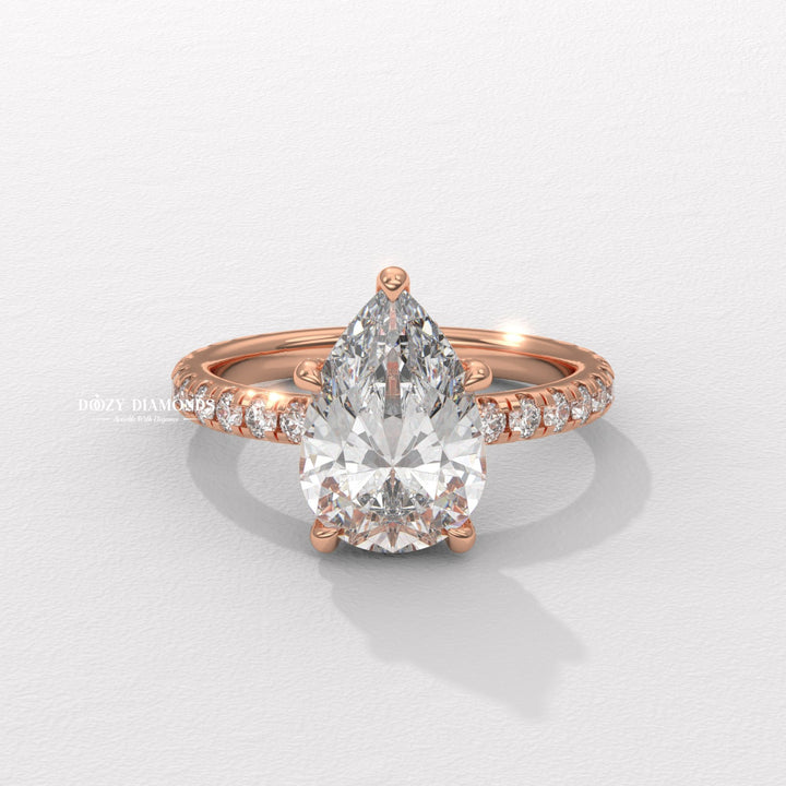 Pear hidden halo engagement ring close-up highlighting diamond sparkle
