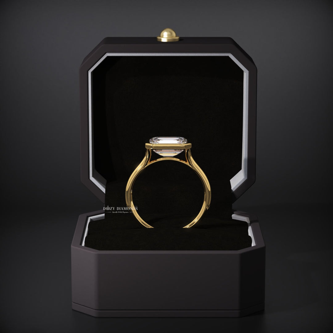 Close-up of emerald cut center diamond in east west engagement ring