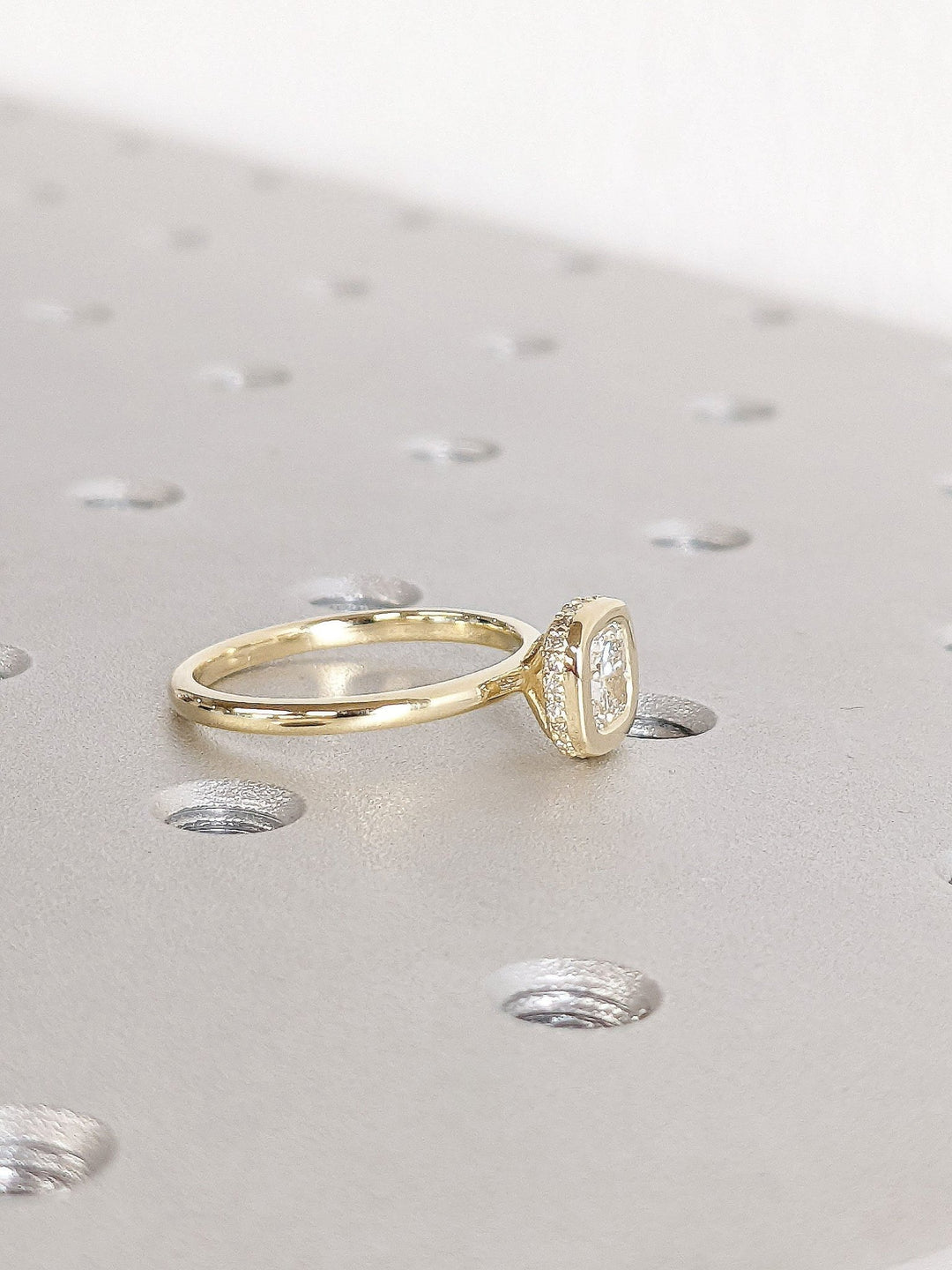 Cushion hidden halo engagement ring close-up showing high clarity diamond clarity