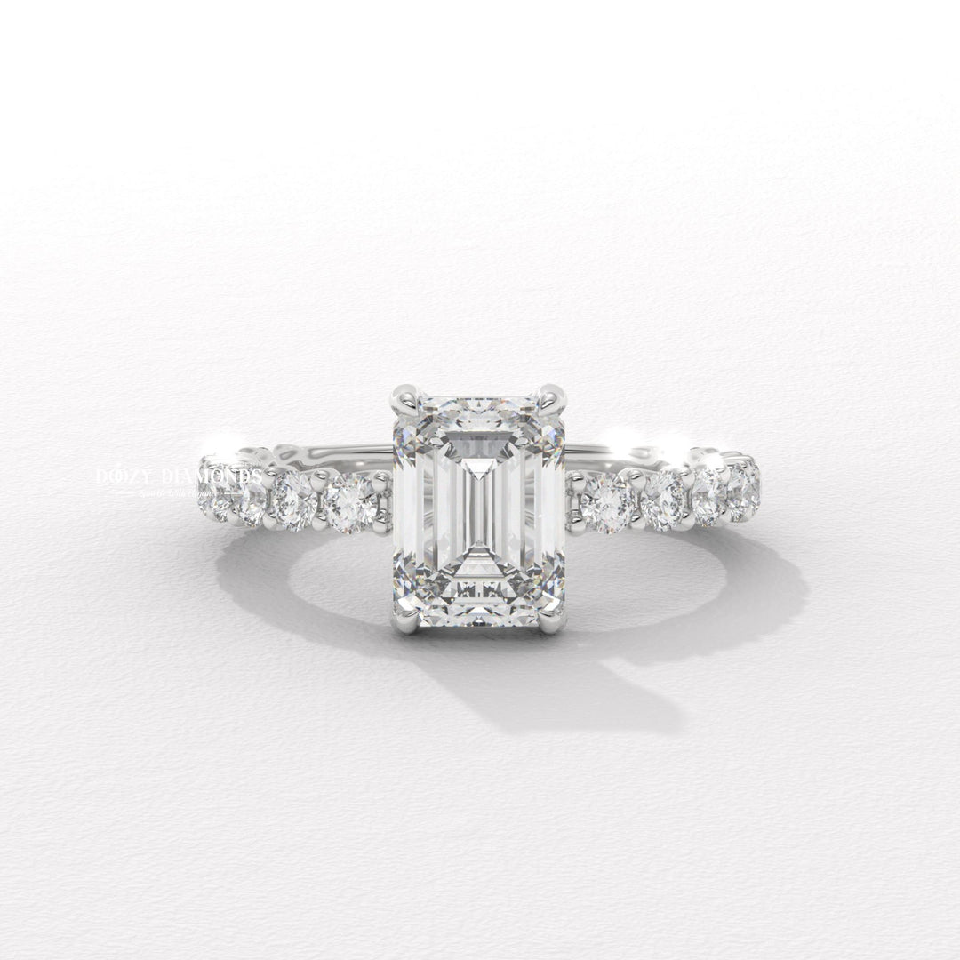Profile view of emerald cut pave engagement ring band