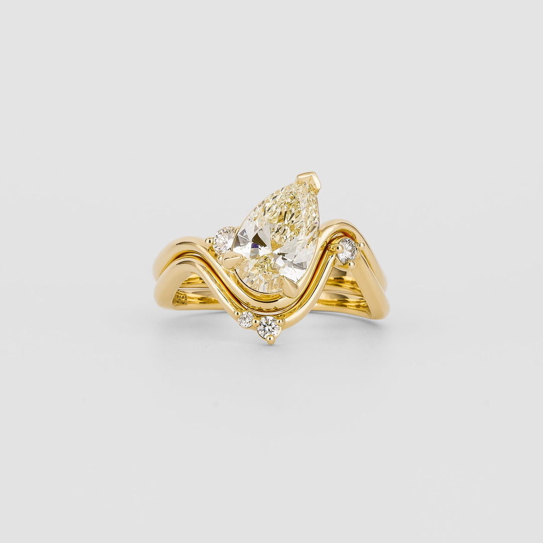 Pear solitaire engagement ring shown on hand for true-to-life sizing