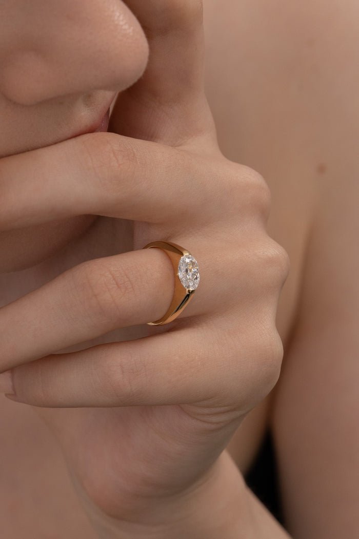 Angled view of oval cut diamond in east west setting