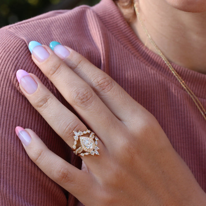 Detailed close-up of pear pave diamond engagement ring
