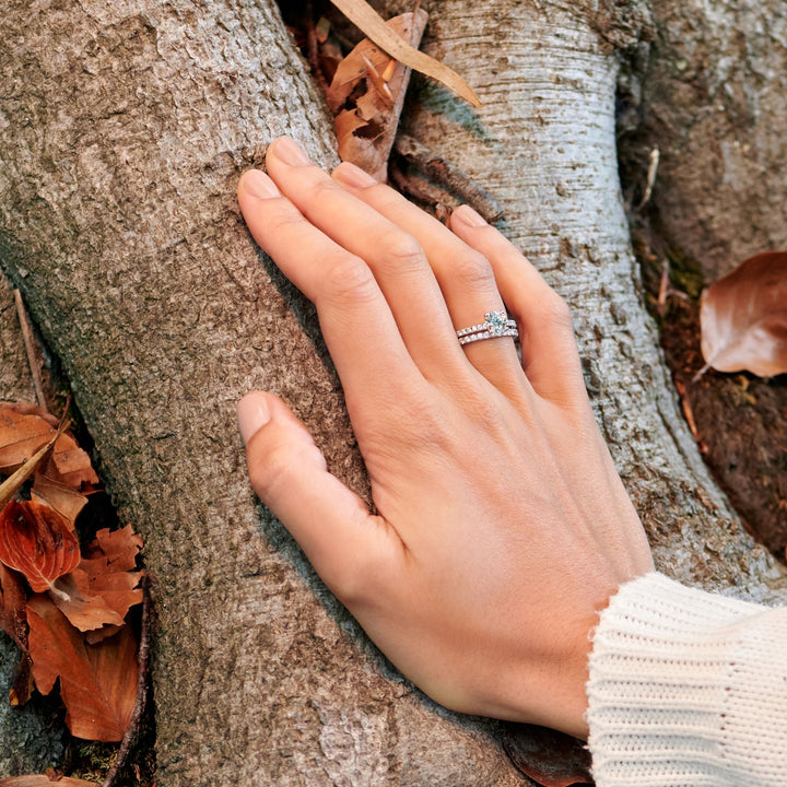 Round pave engagement ring viewed from the side