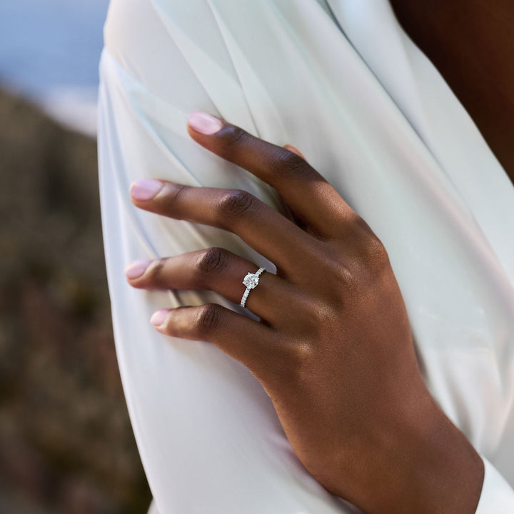 Round pave engagement ring shown on hand for true-to-life sizing