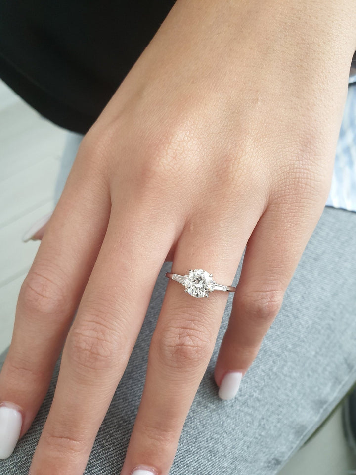 Profile view of round cut three stone engagement ring band