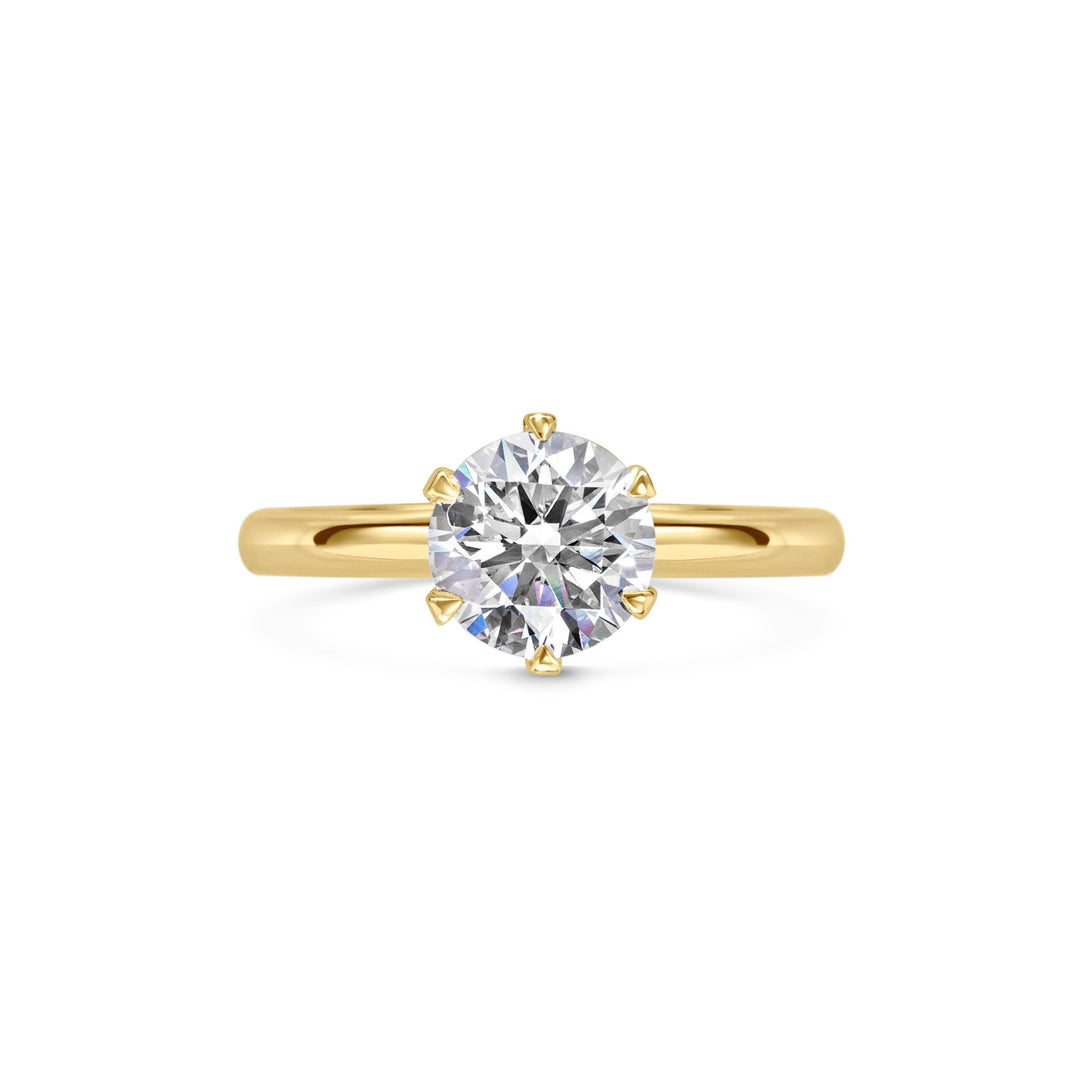 Round solitaire engagement ring close-up showing F-/VS1 diamond clarity