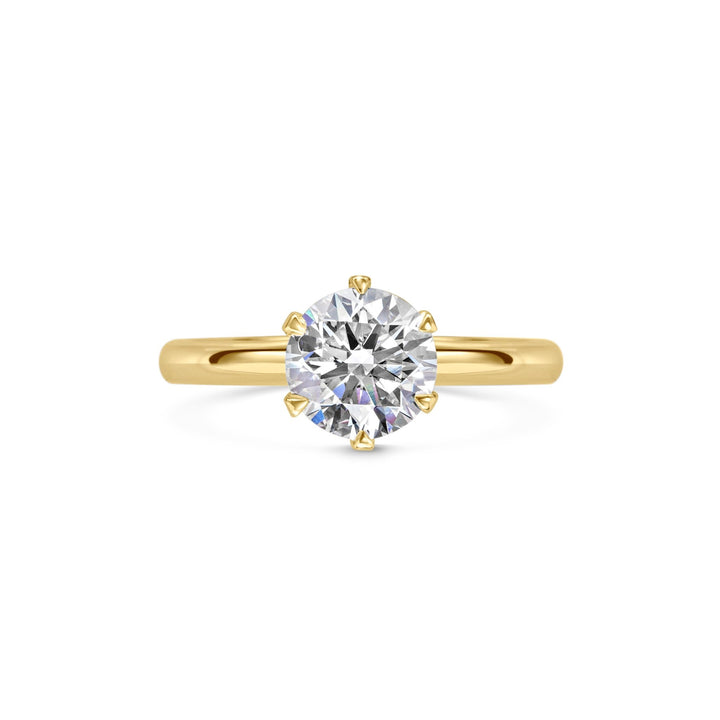 Round solitaire engagement ring close-up showing F-/VS1 diamond clarity