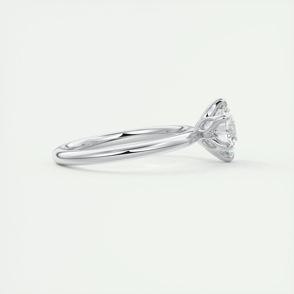 Round solitaire engagement ring photographed in natural light